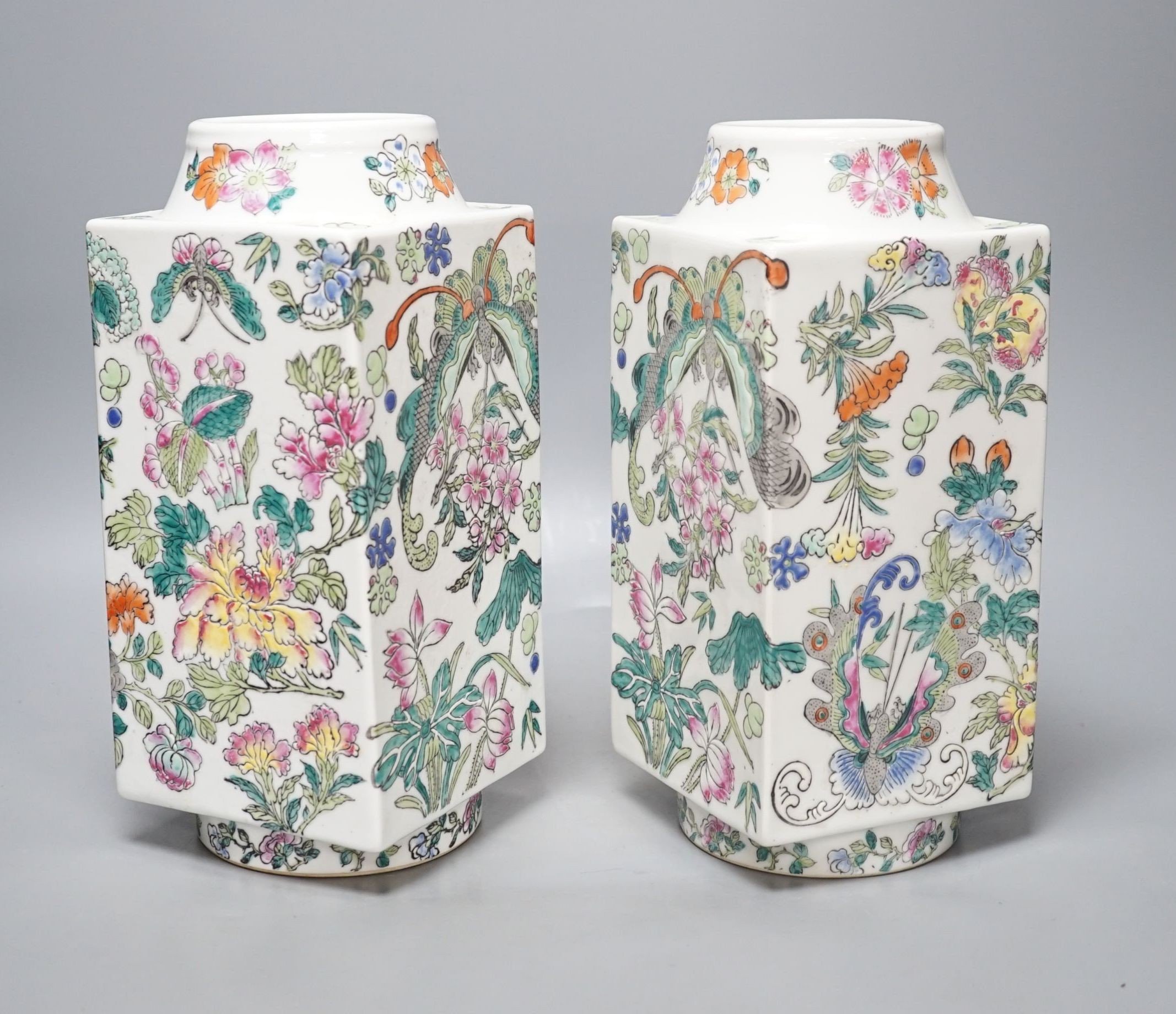 A pair of Chinese famille rose cong shaped vases, 28cms high.